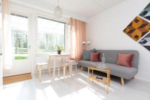 a living room with a couch and a table at Cosy studio apartment + free private parking in Kangasala