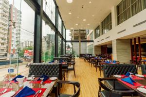 a restaurant with tables and chairs with blue napkins at Best Western Heritage in Cox's Bazar