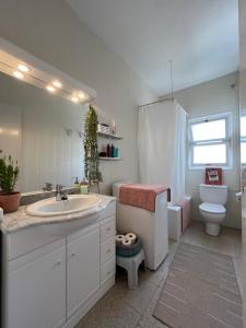 a white bathroom with a sink and a toilet at Calma Marína Roses in Roses