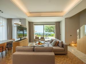 a living room with a couch and a table at Sherwood Exclusive Kemer - Kids Concept in Kemer