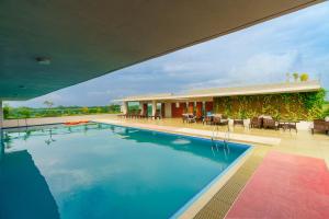 a large swimming pool in front of a building at Best Western Heritage in Cox's Bazar