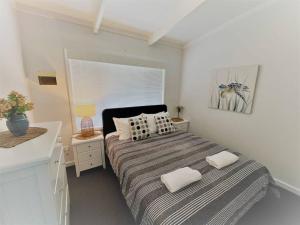 a bedroom with a bed with two pillows on it at Three Palms Apartments Unit 1 in Esperance