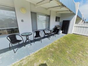 a group of chairs and tables on a patio at Three Palms Apartments Unit 1 in Esperance