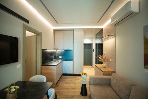 a living room with a couch and a kitchen at FAEL Luxury Apartments in Vlorë