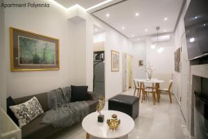 a living room with a couch and a table at Polymnia & Melpomene by Heloni Apartments in Athens