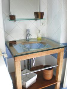 a bathroom sink with a glass counter top at La Maison Des Vendangeurs in Villesèque-des-Corbières +17 photos