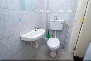 a bathroom with a toilet and a sink at Superb Studio Apartment in Nairobi