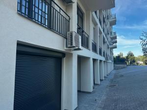 a building with two garage doors on the side of a street at Oxygen studio in Jupiter