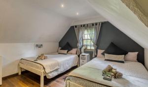 En eller flere senge i et værelse på B&B Sauvignon Country Lodge