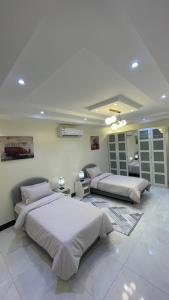 a bedroom with two beds and a room with at H5-hاتش5 in Madīnat Yanbu‘ aş Şinā‘īyah