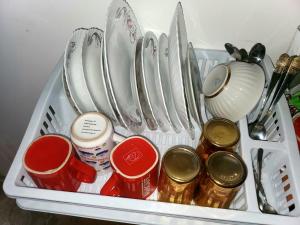 a tray with utensils and other items in a refrigerator at Green Palma in Kutaisi