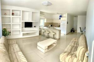 a large living room with a couch and a kitchen at Family House in Natanya in Netanya