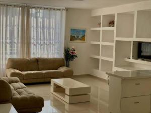 a living room with a couch and a coffee table at Family House in Natanya in Netanya