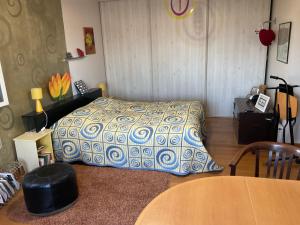 a bedroom with a bed and a table in it at Maison Bon Ton in Paraza