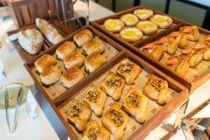 a bunch of pastries in trays on a table at Renaissance Zhuhai Hotel in Zhuhai