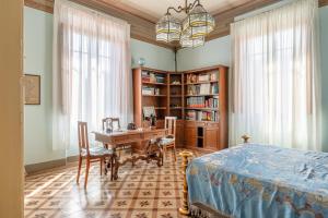a bedroom with a desk and a bed and a table at Villa Lenzi in Lucca