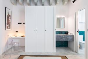 a bathroom with white cabinets and a sink at Magno Apartments Fabiola 7 Luxury House in Seville