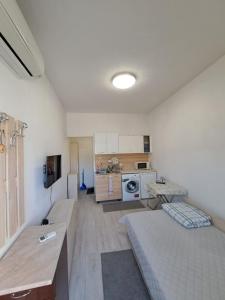 a small room with a bed and a kitchen at relax in Plovdiv