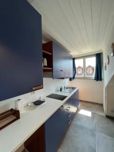 a kitchen with a sink and a refrigerator at Suite The Roof in Turin