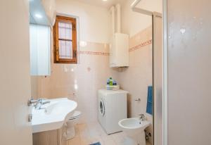 a white bathroom with a sink and a toilet at Podere San Lorenzo in Siena