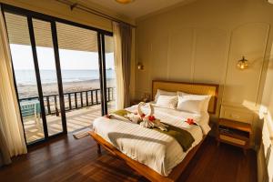 a bedroom with a bed with a view of the ocean at Sea Escape Koh Chang in Ko Chang