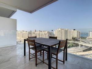 a table and chairs on a balcony with a view of a city at Five Palm Hotel and Residence - Platinium Dubai in Dubai