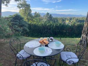 a table with food on top of it with chairs at La Sauveterre in Mours-Saint-EusÃ¨be