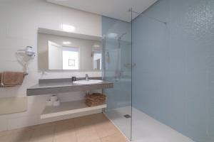 a bathroom with a sink and a glass shower at Apartamentos Elena in Puerto del Carmen