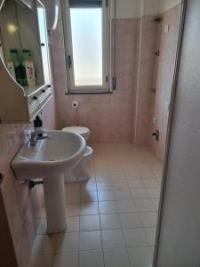 a bathroom with a sink and a toilet and a mirror at Nuovaiegi in Isola Capo Rizzuto