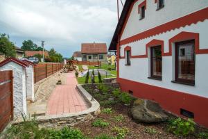 une maison avec une passerelle en briques à côté d'un bâtiment dans l'établissement Wellness chalupa Podolí, à Mladá Vožice