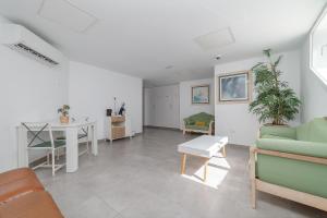 a living room with a couch and a table at Apartamentos Elena in Puerto del Carmen