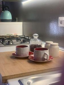two cups on plates on a counter in a kitchen at Attico96 Intero appartamento in centro storico in Marostica