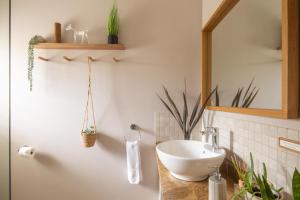 a bathroom with a sink and a mirror at Woodlands Self Catering in Phantom Acres