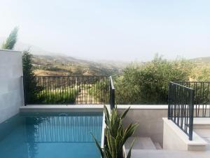 a swimming pool with a view of the mountains at Casa Rural Reserva de las Nieves in Tolox