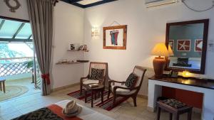 a living room with a bed and a fireplace at Pinewood Beach Resort and Spa in Diani Beach