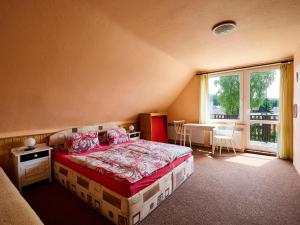 a bedroom with a bed and a large window at Apartment Nový Svět by Interhome in Harrachov