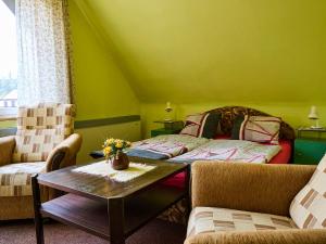 a green room with a table and a bed at Apartment Nový Svět by Interhome in Harrachov