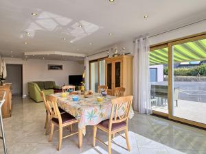 a dining room with a table and chairs and a kitchen at Holiday Home Ty Ker by Interhome in Lannion