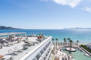 a view of the beach from the balcony of a resort at Hotel Condesa in Port d'Alcudia