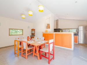 a kitchen with a wooden table and chairs in a room at Holiday Home Arbelle by Interhome in Saint-Cézaire-sur-Siagne