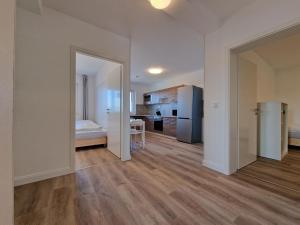an empty apartment with a kitchen and a bedroom at Tolstov Apartments - 4 Room Apartments - 30 Min Messe DUS in Neuss +38 photos