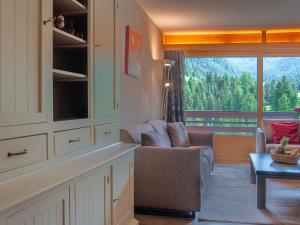 a living room with a couch and a table and a window at Apartment Rosablanche C51 by Interhome in Siviez +20 photos