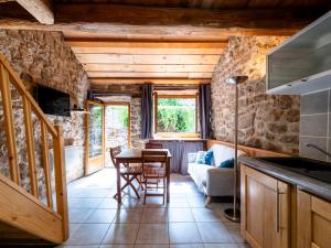 a kitchen and living room with a table and chairs at Holiday Home Chassezac by Interhome in Sainte-Marguerite-Lafigère