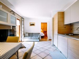 a kitchen and a living room with a table at Apartment Carmen-3 by Interhome in Soraga