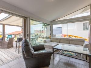 a living room with a couch and a table at Holiday Home Les Baïnes - VIB220 by Interhome in Vieux-Boucau-les-Bains