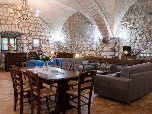 a living room with a table and a couch at Apartment La Capraccia-5 by Interhome in Bagnoregio +25 photos