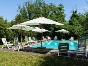 een zwembad met stoelen en parasols ernaast bij Apartment La Capraccia - BOL334 by Interhome in Bagnoregio