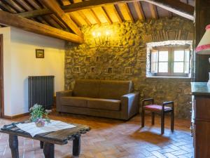 a living room with a couch and a table at Apartment La Capraccia-7 by Interhome in Bagnoregio