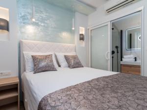 a bedroom with a large bed and a bathroom at Apartment Mornar-3 by Interhome in Trogir