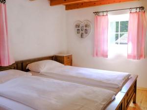 two beds in a bedroom with pink curtains and a window at Holiday Home Casa Felice by Interhome in Anvéuda